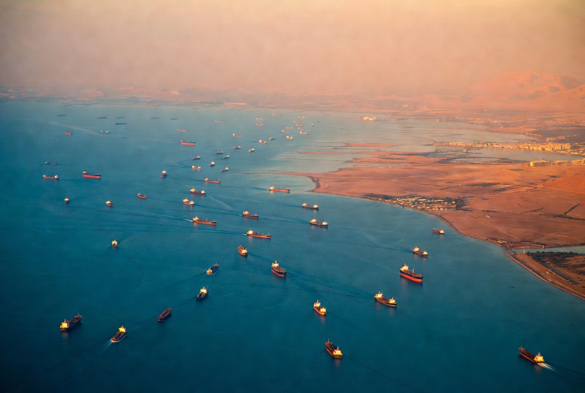 Aerial view of oil tankers passing through the Strait of Hormuz at golden hour after Iran reopened the strait April 17 2026